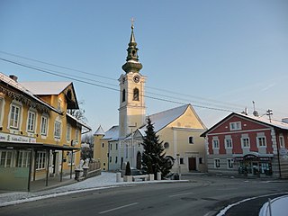 Ortszentrum von Sigharting mit Pfarrkirche und Schloss im Hintergrund