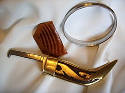 Wooden comb, iron bracelet and curved, gold-coloured dagger