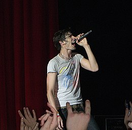 A man sings passionately into a microphone