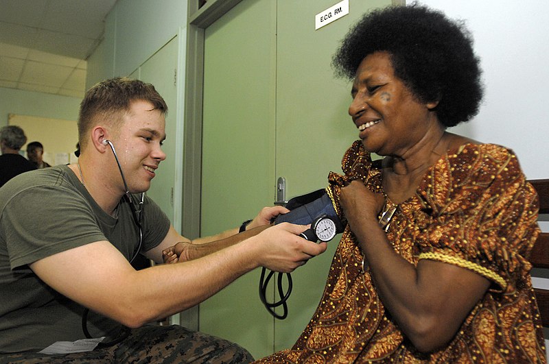 File:US Navy 070808-N-4954I-021 Hospitalman Brian Robinson removes a blood pressure cuff from a local resident at Modilon General Hospital in support of Pacific Partnership.jpg