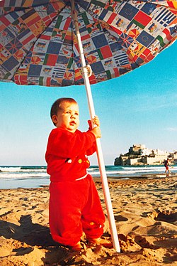 Very young "lady in red" under a parasol in Spain