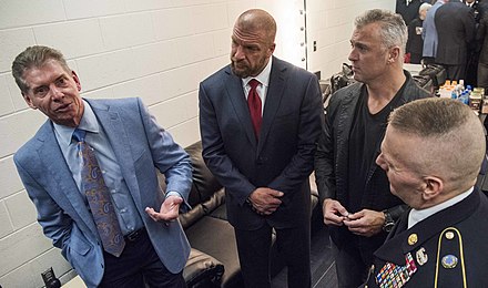 McMahon talks to Command Sgt. Maj. John W. Troxell before the 2016 WWE Tribute to the Troops event, as his son-in-law Paul Levesque and his son Shane look on