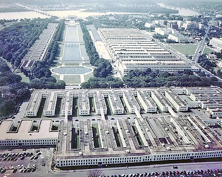Westward view from the top of the Washington Monument in 1943 or 1944 during World War II. In the foreground, temporary buildings on the Washington Monument grounds house the Navy's Bureau of Ships. The Main Navy and Munitions Buildings stand to the right of the Lincoln Memorial Reflecting Pool. Temporary buildings to the left of the Reflecting Pool house the Navy's Bureau of Supplies and Accounts.[82]