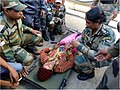 (Capt Febha Susan of the Indian Army, walked 15 kms to reach the pregnant ladies in Tajim.) Mrs. Pooja being examined by Capt. F.S. Varkey, RMO Kumaon Scouts.jpg