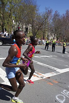 Jemima Jelagat Sumgong and Sharon Cherop racing in the final stage of the women's race 2012 Boston Marathon - Cherop and Sumgong last turn.jpg