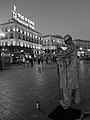 A street performer at Puerta del Sol in Madrid, Spain with the Tío Pepe advertisement in the distance