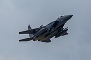 An F-15E Strike Eagle, tail number 91-0320, taking off from RAF Lakenheath in England. The aircraft is assigned to the 494th Fighter Squadron.