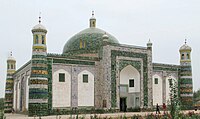 Afaq Khoja Mausoleum, a rectangular building with a dome in the middle, a large gate in the front, and four minaret towers on each corner.