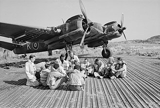 The flame dampers on the bottom of the engine on this Bristol Beaufighter were typical for 1940s RAF aircraft with radial engines. Aircrew of No. 16 Squadron SAAF and No. 227 Squadron RAF sitting in front of a Bristol Beaufighter at Biferno, Italy, prior to taking off to attack a German headquarters building in Dubrovnik, Yugoslavia, 14 August 1944. C5894.jpg