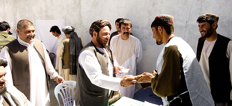 File:Amir Mohammad Akhundzada, center, the governor of Uruzgan province, Afghanistan, presents a new voter registration card to a Tarin Kowt resident in the province May 26, 2013 130526-D-ZZ999-001.jpg