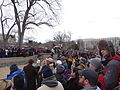 Distant view of anti-abortion protester Rives Grogan perched high in a tree on the south lawn of the west face of the US Capitol during the 2013 US Presidential Inauguration. Viewed from First St SW just south of the midpoint between Peace Circle and Garfield Circle, Washington, DC.