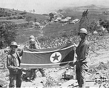 Les soldats tiennent un drapeau nord-coréen