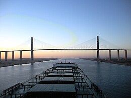 Post-deepening of the Suez Canal, larger ships pass through the canal - in this case, a capesize bulk carrier approaches the Egyptian-Japanese Friendship Bridge Capesize bulk carrier at Suez Canal Bridge.JPG