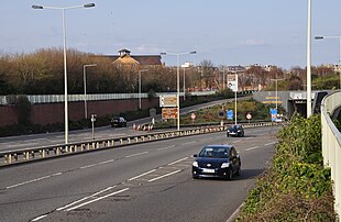 A junction with the A4232 dual carriageway as the route winds into a tunnel beneath Cardiff Bay