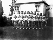 Chorus line in 1944 - The Soubrettes. The photograph was possibly taken at the back of the Cremorne Theatre. The Victoria Bridge can be partially seen at left, background. Chorus line the Soubrettes at the Cremorne Theatre South Brisbane ca 1944.tif