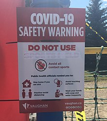 COVID-19 safety notice on playground equipment at a park in Vaughan Closure notice at Vaughan park (cropped).jpg