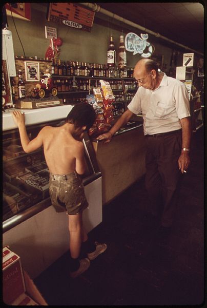 File:DON GARRISON, 65, WITH YOUNG CUSTOMER, AT HIS STORE IN NEW LINN CREEK, WHERE HE HAS OPERATED A RESTAURANT, A HOTEL... - NARA - 551342.jpg