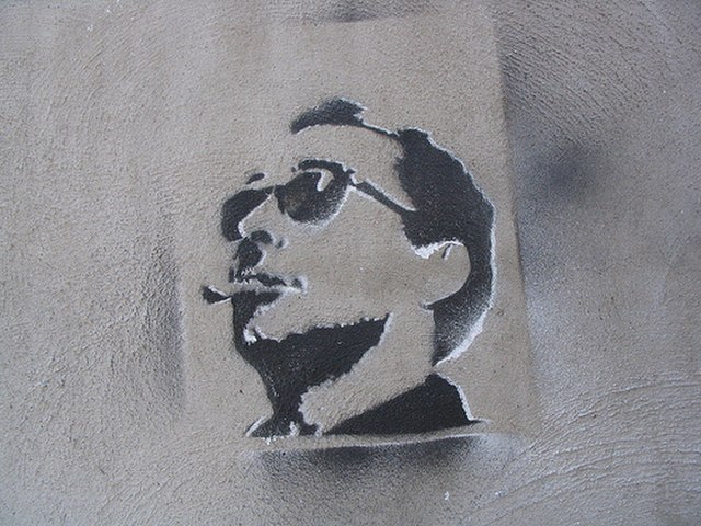 A pochoir depicting Godard on a wall in Montreal.