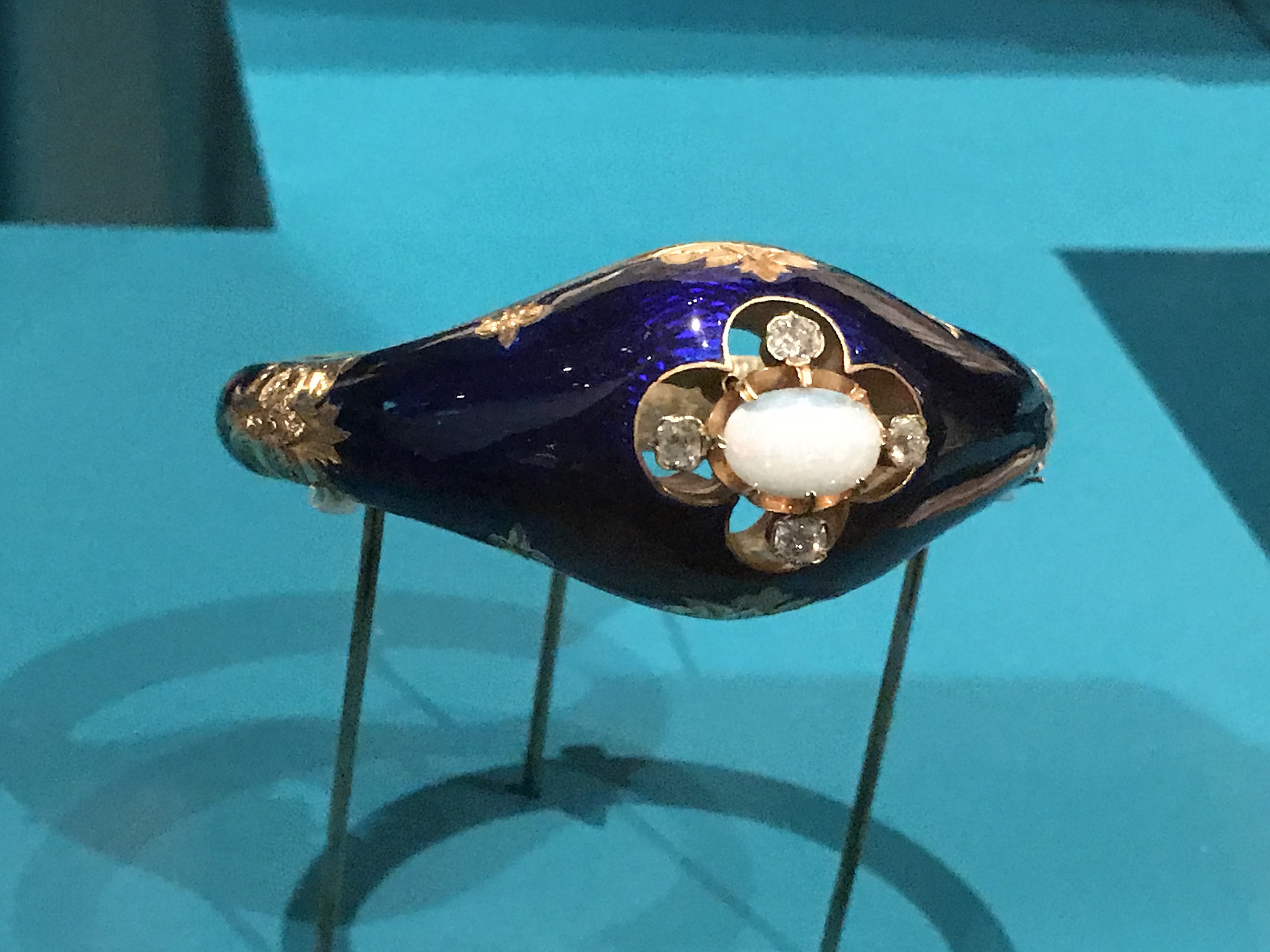 https://upload.wikimedia.org/wikipedia/commons/thumb/f/fb/Gold%2C_blue_enamel_and_opal_bracelet.jpg/2560px-Gold%2C_blue_enamel_and_opal_bracelet.jpg