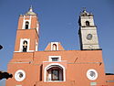 Church's two towers, one in Spanish style, other in English style