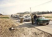 IDF soldier checking a car at a road block near Jabalia during the first intifada.