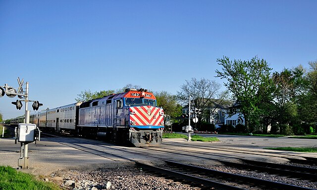 A Union Pacific Northwest Line train led by an EMD F40PH in the Norwood Park neighborhood of Chicago, Illinois