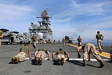 Marines with Golf Company of 2nd Battalion conduct physical training on the flight deck of the USS Makin Island during Amphibious Squadron Marine Expeditionary Unit Integration, off the coast of San Diego, California, April 2014. Marines conduct physical training aboard USS Makin.jpg