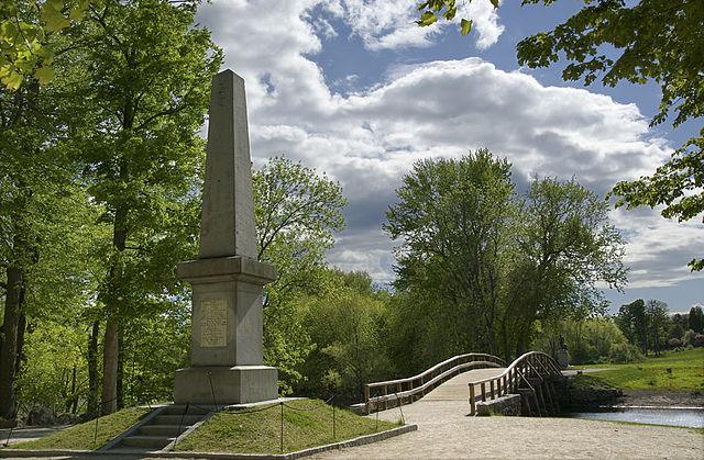 The 1836 obelisk with The Minute Man in the background on the other side of the Concord River