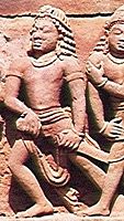 Male warrior holding broad sword wearing dhoti and arm bracelets; Gupta era statues.