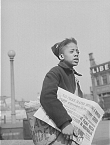 Newsboy selling the Chicago Defender, a leading African American newspaper. April 1942.