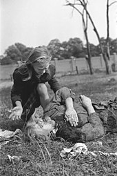 A girl cries over the body of her 14-year-old sister who was strafed by the Luftwaffe Polish victim of German Luftwaffe action 1939.jpg