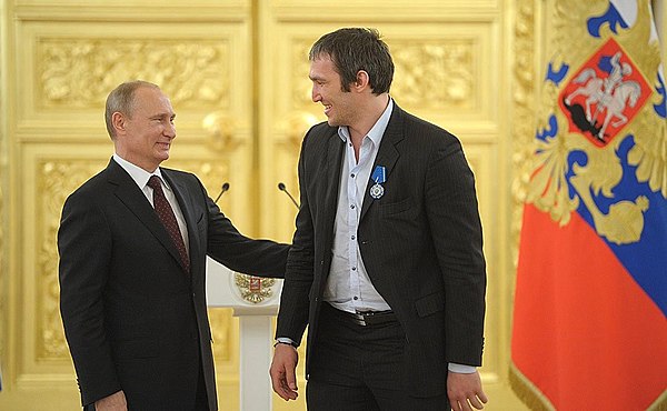 Vladimir Putin and Russian team captain Alexander Ovechkin