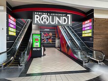 The escalators leading to and from the second-floor Round One Round 1 Maine Mall.jpg