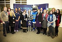 Representatives of the game with the trophy at Leeds Central Library. Rugby League World Cup Event at Leeds Central Library (Taken by Flickr user 9th February 2013).jpg