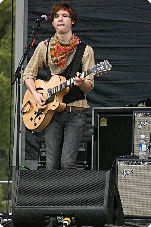 Former guitarist and vocalist Ryan Ross performing with the band in 2007. Ross was responsible for writing most of the music and lyrics until his depa