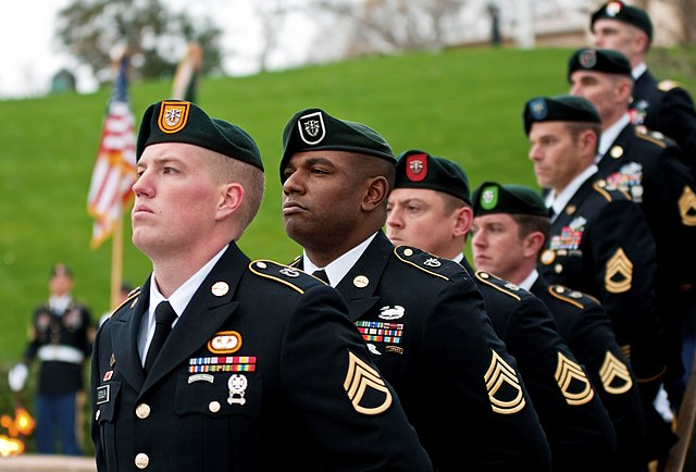 Soldiers from each of the Army's seven Special Forces Groups (beret patches, l. to r., of 1st, 5th, 7th, 10th, 19th, 20th and 3rd SFG) at the gravesit