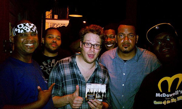 Actor Seth Rogen holding up a copy of the "Unlock Your Mind" CD and hanging out with The Soul Rebels at Le Bon Temps Roule in 2012