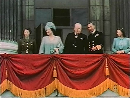 Elizabeth (far left) on the balcony of Buckingham Palace with her family and Winston Churchill on 8 May 1945