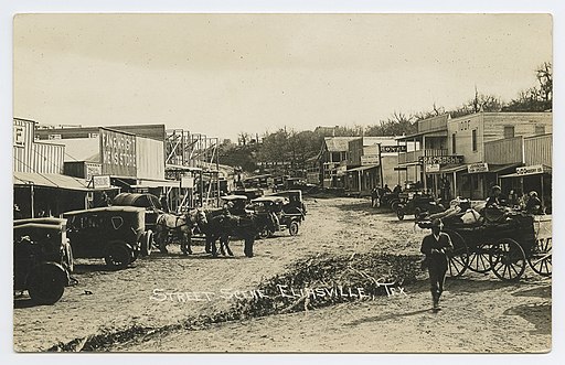 street scene in eliasville texas circa 1918 with cars and horses in dirt road