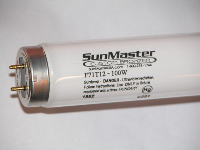 Typical F71T12 100 W G13 bi-pin lamp used in tanning beds. The (Hg) symbol indicates that this lamp contains mercury. In the US, this symbol is now re