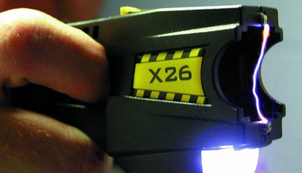 A TASER device, with cartridge removed, making an electric spark between its two electrodes