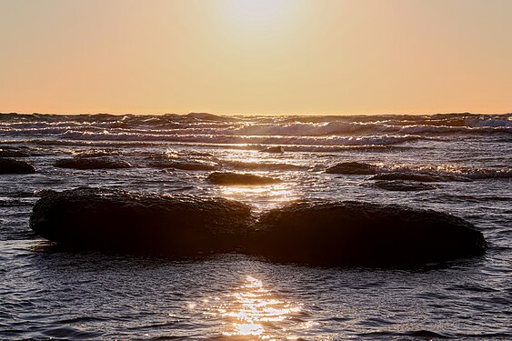 two rocks at beach in last sunlight of the day