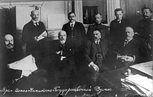 Nine members of the Provisional Committee of the State Duma in March 1917. From left to right:
Seated: V. N. Lvov, V. A. Rzhevsky, S. I. Shidlovsky, and M. V. Rodzianko (Chairman);
Standing: V. V. Shulgin, B. A. Engelhardt, A. F. Kerensky, and M. A. Karaulov. Vremenniy komitet gozdumy 1917.jpg