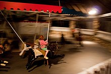 A child rides the carousel Watch Hill carousel.jpg