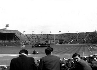 A marching band entertains the incoming crowd prior to the 1956 Rugby League Cup Final Wembley Stadium interior 1956.jpg