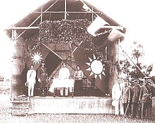 Sun Yat-sen (middle) and Chiang Kai-shek (on stage in uniform) at the founding of the Whampoa Military Academy in 1924. Whampoa3.jpg