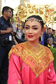 Herman wearing traditional Minangkabau dress, during 2018 Asian Games torch relay on 18 July 2018.[46]