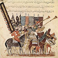 A group of riders with flags, standards and musical instruments, including two long trumpets, nafir. From the 1237 manuscript of Al-Hariri of Basra's Maqamat. (BNF ms. arabe 5847). Yahya ibn Mahmud al-Wasiti 006.jpg