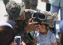 A child tries on a Kevlar helmet during the Marine Corps Air Station Iwakuni Friendship Day 2016 Air Show, 5 May 2016.