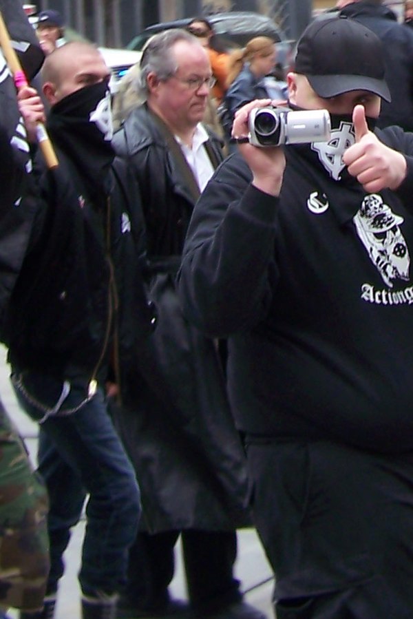 Fromm (middle person wearing glasses and no mask) marching with neo-Nazi Aryan Guard members in Calgary, Alberta on March 21, 2009